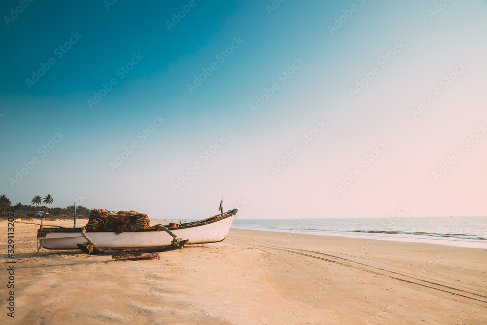 Goa, India. Old Wooden Fishing Boat Standing On Sea Ocean Beach. Tropical Palms On Background - obrazy, fototapety, plakaty 