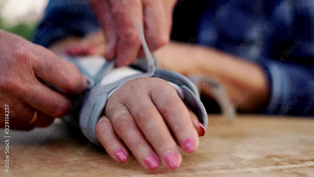 Senior man helping her wife with broken arms. Senior man helping her wife with broken arms.