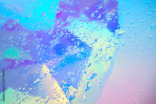 holographic plastic with water drops. abstract background © ninanaina