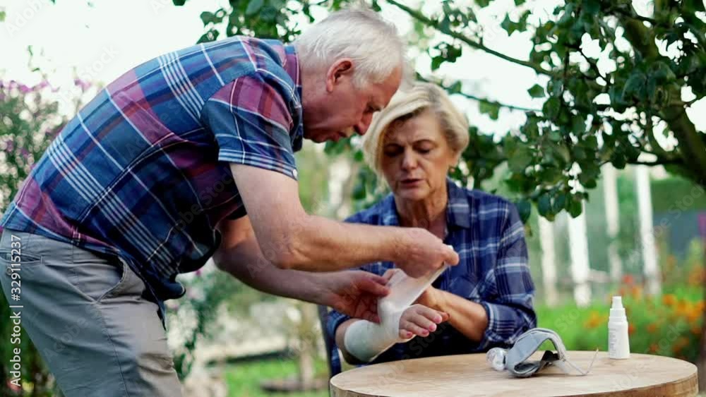 Senior man helping her wife with broken arms. Senior man helping her wife with broken arms.