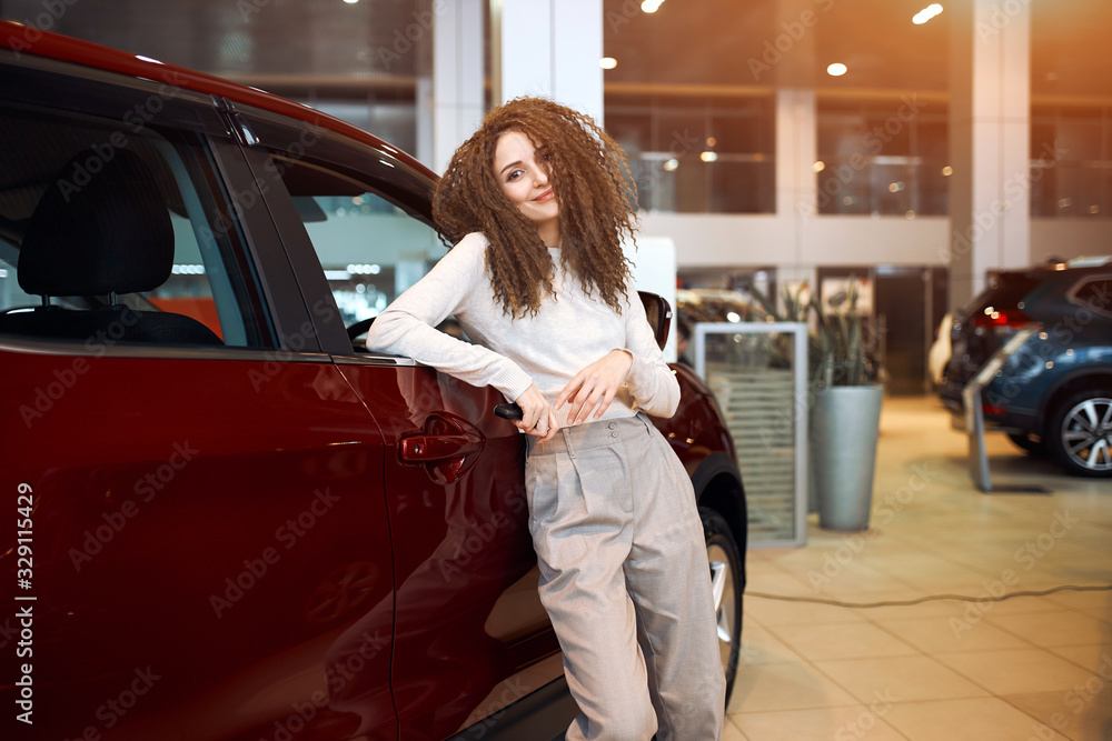 attractive happy car owners posing to the camera in the show room, close up photo. success, bargain, lifestyle, dealer having free time at workplace, spare time, interest attractive happy car owners posing to the camera in the show room, close up photo. success, bargain, lifestyle, dealer having free time at workplace, spare time, interest