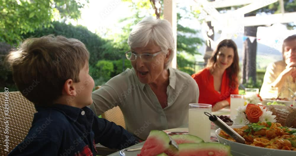 Family eating outside together in summer Family eating outside together in summer