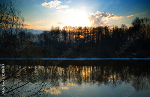 Dramatic sunset on spring river background