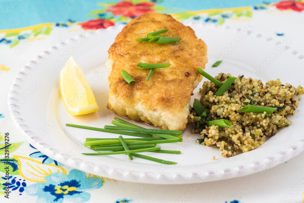 Fried light breaded cod fish.