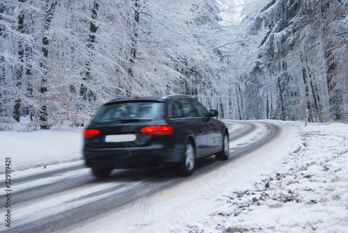 Black car in a frozen winter forest