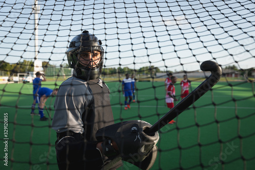 Side view of a Caucasian male field hockey goalkeeper photo