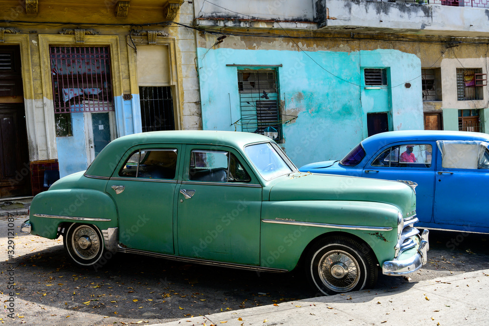 Vintage cars parked outside houses, Havana, Cuba
