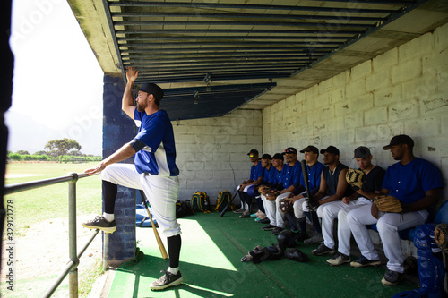 Baseball players relaxing in dugout before match photo
