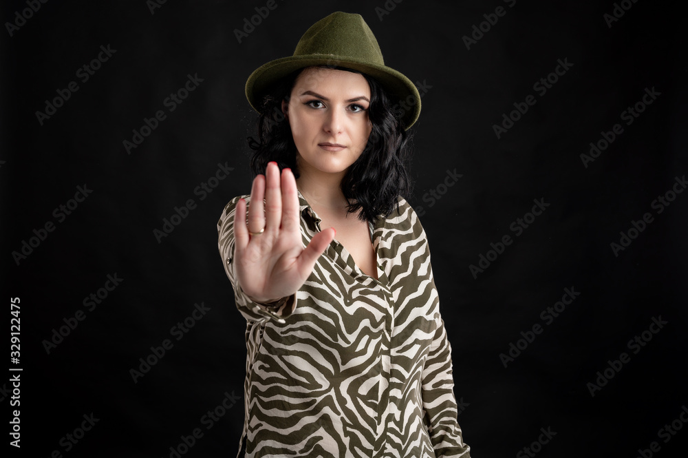 Attractive young woman dressed casually showing stop with hand Attractive young woman dressed casually showing stop with hand