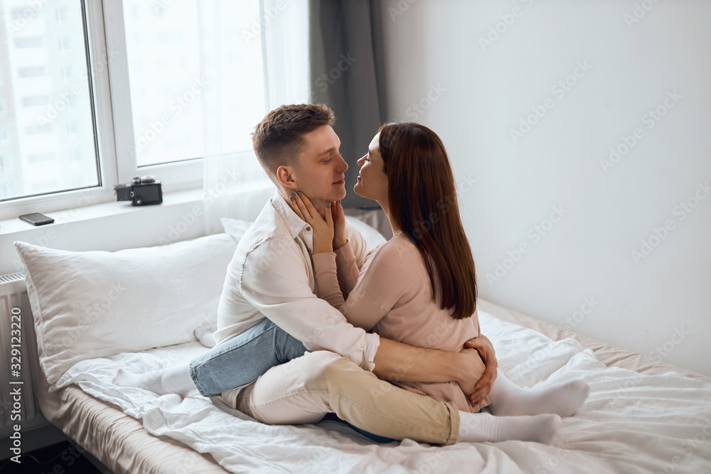 young beautiful woman closing her eyes touching her boyfriend neck, hugging him, happiness, enjoyment. side view full length photo.sexuality.Happy strong marriage young beautiful woman closing her eyes touching her boyfriend neck, hugging him, happiness, enjoyment. side view full length photo.sexuality.Happy strong marriage