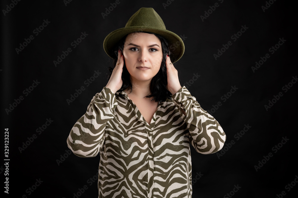 Attractive young woman dressed casually in the hear no Evil Attractive young woman dressed casually in the hear no Evil
