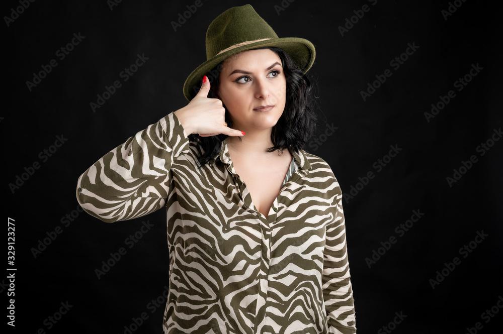 Attractive young woman dressed casually showing call me gesture Attractive young woman dressed casually showing call me gesture