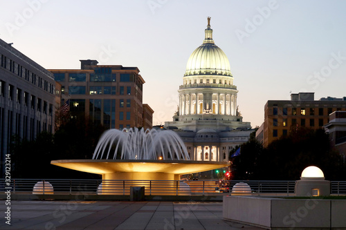 Wisconsin State Capitol building. National Historic Landmark. Madison, Wisconsin, USA. Twilight scene with  illuminated fountain in the foreground. Vertical view from Monona terrace balcony. photo