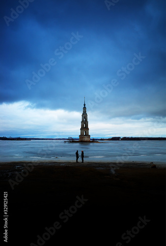 Two man standing near bell tower background