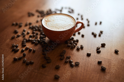 Steaming cup of latte with heart shape few coffee beans. still life. close up photo. coffee break