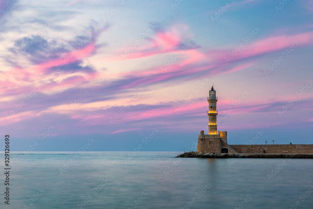 Venetian harbour and lighthouse in old harbour of Chania at sunset, Crete, Greece. Old venetian lighthouse in Chania, Greece. Lighthouse of the old Venetian port in Chania, Greece.