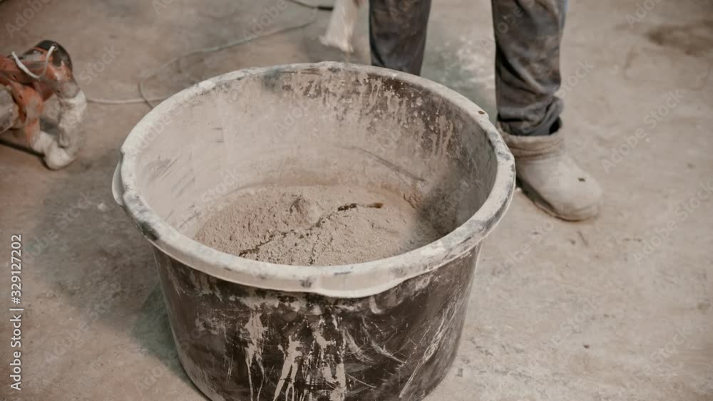 Concrete industry - worker in gloves about to mix the concrete Concrete industry - worker in gloves about to mix the concrete