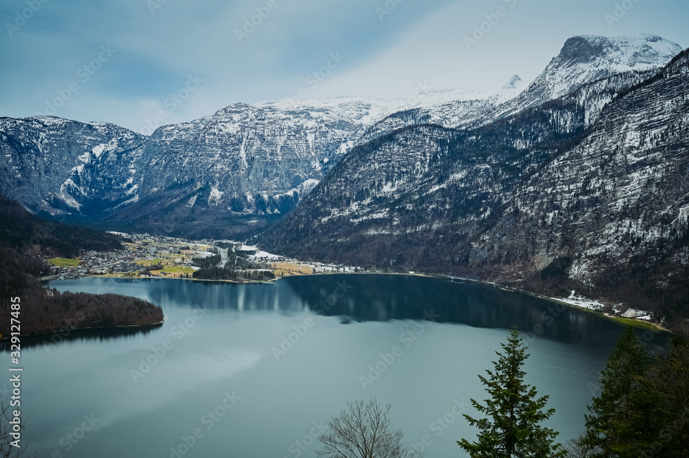 Top view from the observation deck of famous Hallstatt mountain village and alpine lake, landscape panorama, Austrian Alps, Austria. Unesco. Salzkammergut region Top view from the observation deck of famous Hallstatt mountain village and alpine lake, landscape panorama, Austrian Alps, Austria. Unesco. Salzkammergut region