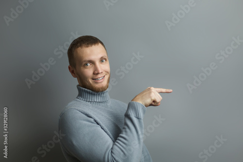 Guy pointing with index finger towards something