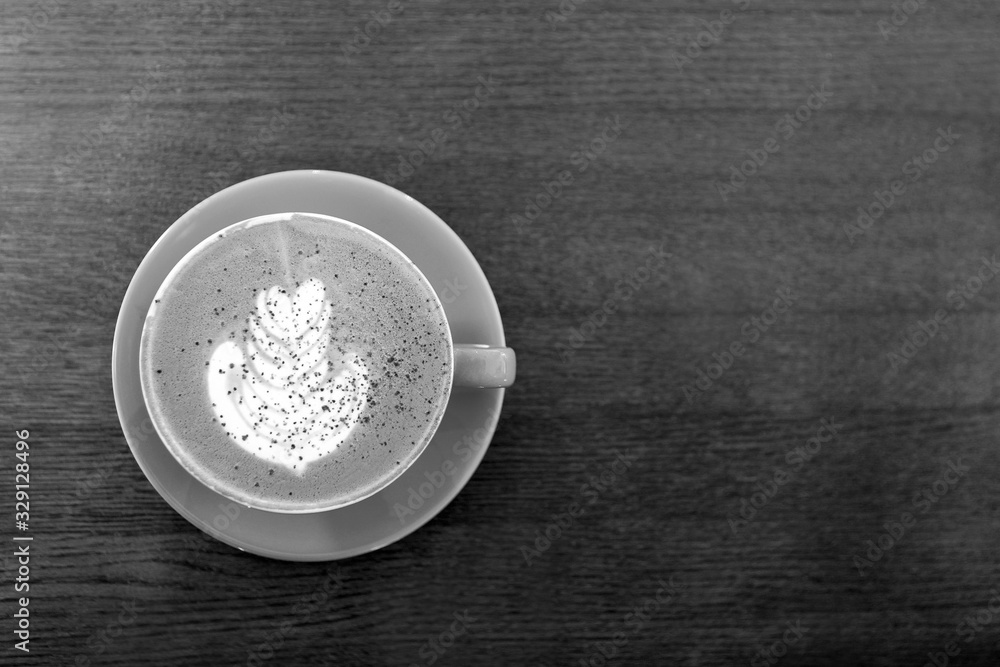 Black and white. Big Coffee cup with milk on the wooden table. cappuccino or latte drink, cup of coffee on table flat lay view. Cup of cafe au lait. Milk paintings. Hot Coffee in a blue mug Black and white. Big Coffee cup with milk on the wooden table. cappuccino or latte drink, cup of coffee on table flat lay view. Cup of cafe au lait. Milk paintings. Hot Coffee in a blue mug
