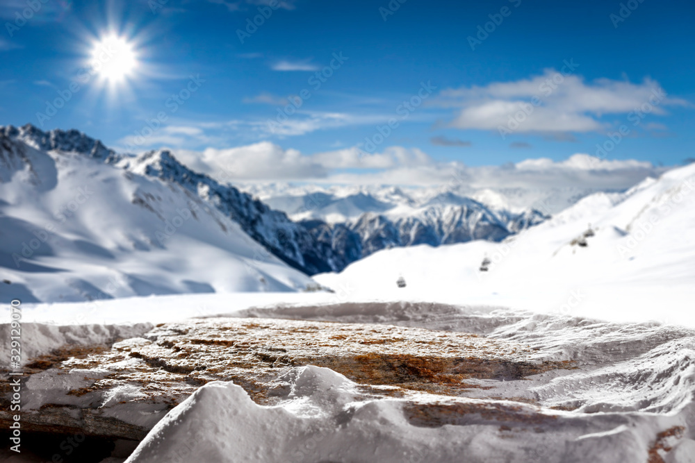 Stone top cover of snow and landscape of mountains with blue sky. 