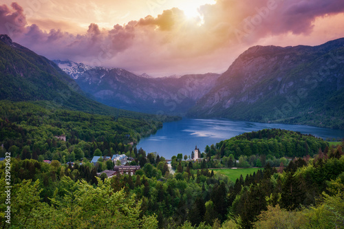 Aerial view of Bohinj lake in Julian Alps. Breathtaking view of the famous Bohinj lake from above. Beautiful view of the Triglav national park and the church of St John the Baptist. Slovenia, Europe © daliu