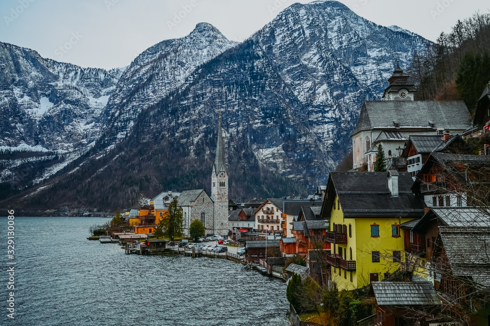 Scenic picture-postcard view of famous Hallstatt mountain village and alpine lake landscape panorama, Austrian Alps, Austria. Landmark with traditional wooden houses. Unesco. Salzkammergut region. Scenic picture-postcard view of famous Hallstatt mountain village and alpine lake landscape panorama, Austrian Alps, Austria. Landmark with traditional wooden houses. Unesco. Salzkammergut region.