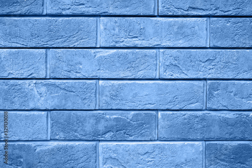 pattern of decorative gray slate stone wall surface as a background. tinted classic blue color trend 2020 year