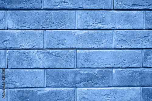 pattern of decorative gray slate stone wall surface as a background. tinted classic blue color trend 2020 year