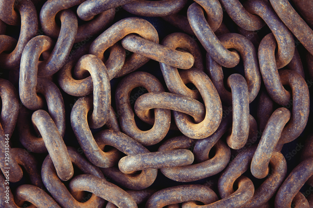 Old rusty chain close-up. Detail of the mechanism. A symbol of strength. Vintage background. Old rusty chain close-up. Detail of the mechanism. A symbol of strength. Vintage background.
