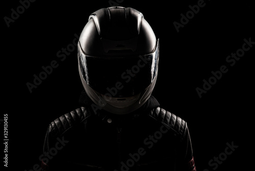 silhouette of a motorcyclist in a helmet and leather jacket