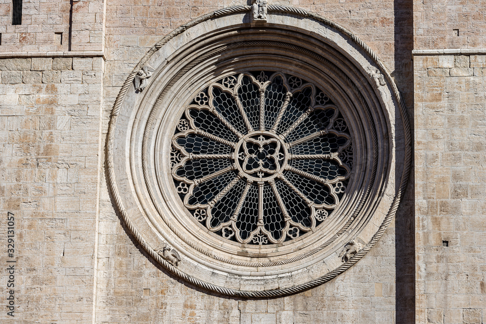 Rose window of the facade of the San Vigilio Cathedral (Duomo di Trento, 1212-1321) in Romanesque and Gothic style. Trento city, Trentino-Alto Adige, Italy, Europe