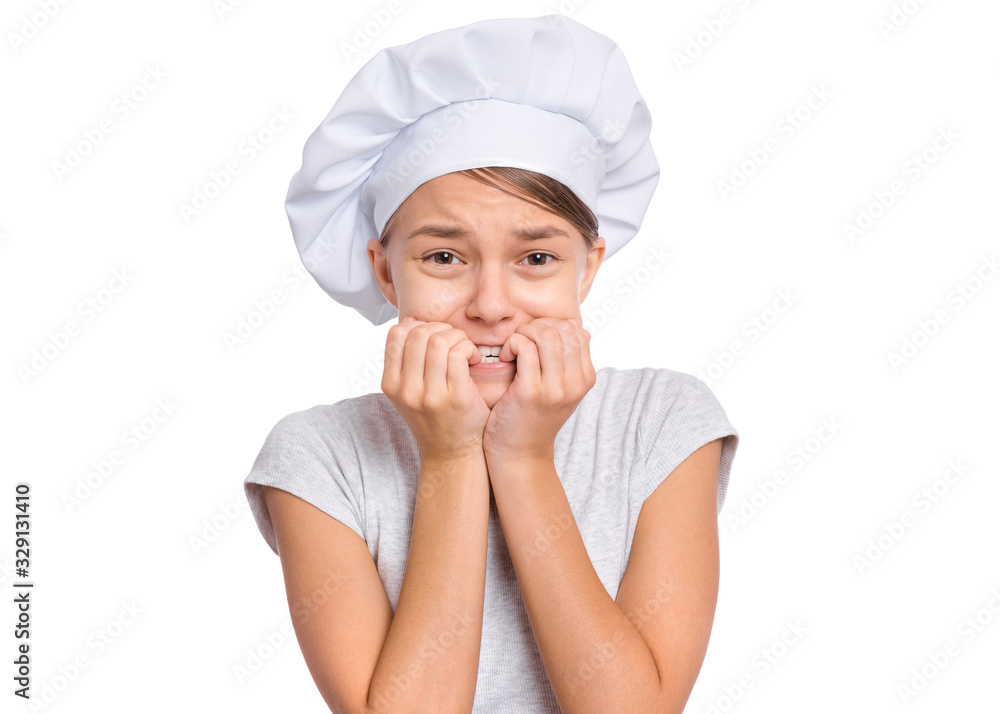 Portrait of beautiful surprised or shocked teen girl in chef hat with hands on mouth biting nails, isolated on white background. Portrait of cute child cook, posing in studio, looking at camera. Portrait of beautiful surprised or shocked teen girl in chef hat with hands on mouth biting nails, isolated on white background. Portrait of cute child cook, posing in studio, looking at camera.