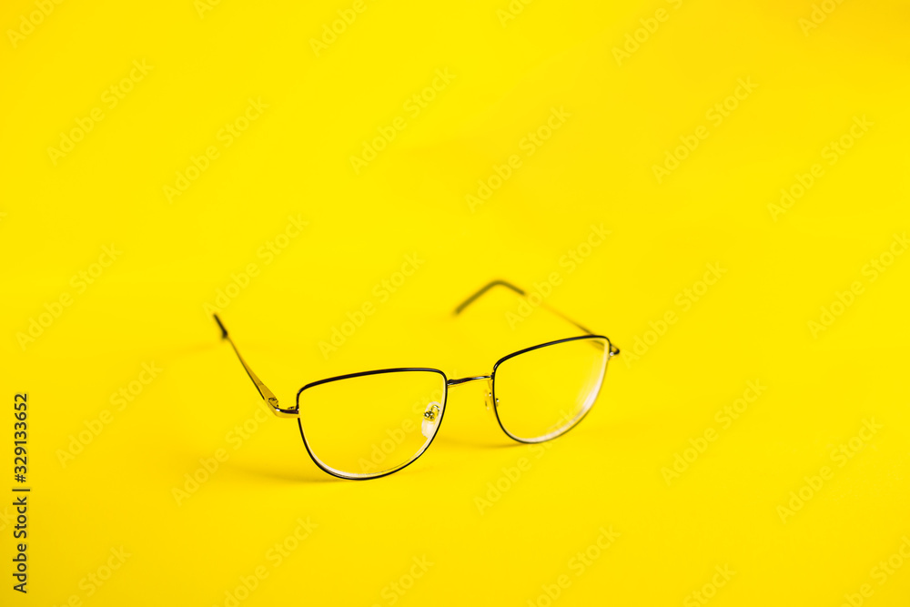 metal retro glasses on a yellow background, myopia metal retro glasses on a yellow background, myopia