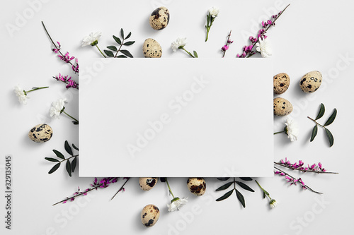 Creative easter flat lay with white paper blank photo