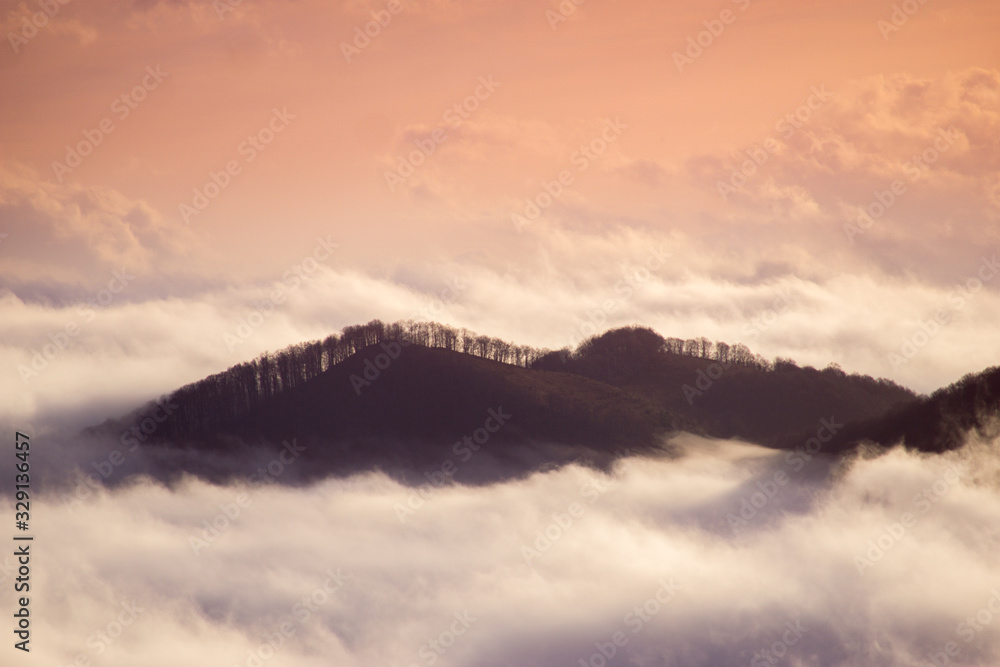 Foggy mountains at sunrise at long exposure. Concept: floating island