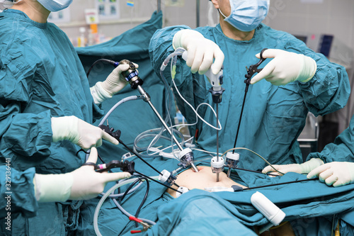 Surgeons team hands during laparoscopic abdominal operation in patient surgery in operating room photo