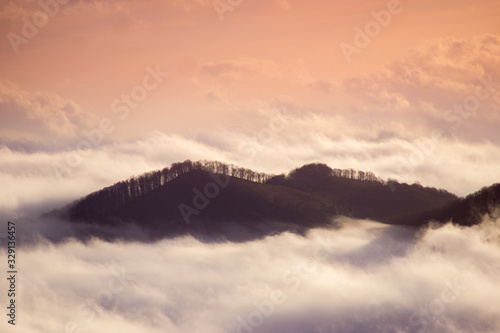 Foggy mountains at sunrise at long exposure. Concept: floating island