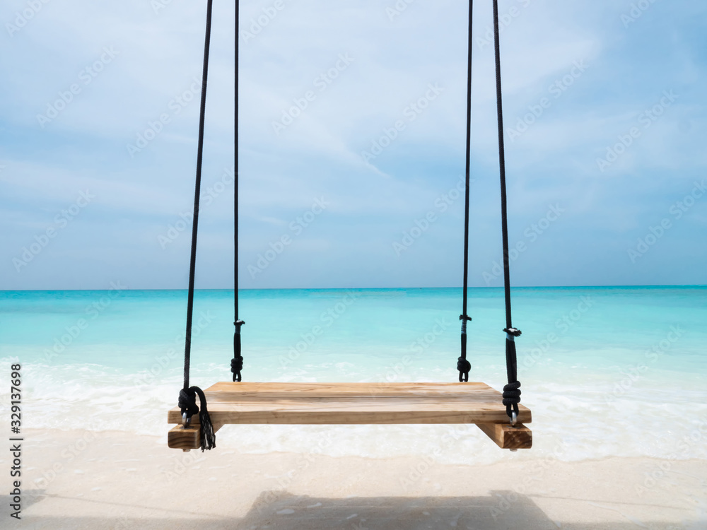 Swings on Tropical Maldivian Island with Turquoise Blue Ocean Sea Water.