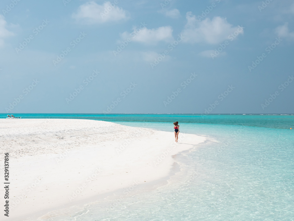 Beautiful Woman Run on the Maldivian Beach.