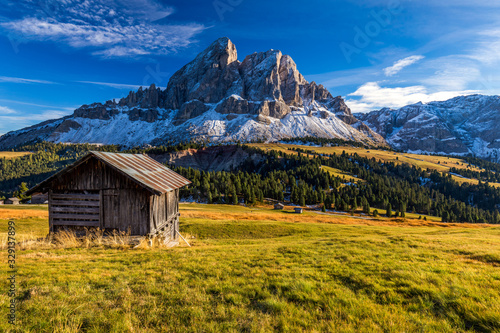 Stunning view of Peitlerkofel mountain from Passo delle Erbe in Dolomites, Italy. View of Sass de Putia (Peitlerkofel) at Passo delle Erbe, with wooden farm houses, Dolomites, South Tyrol, Italy. © daliu