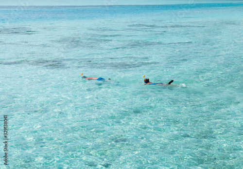 Pair of Snorkeler in Turquoise Maldivian Waters. © BooblGum