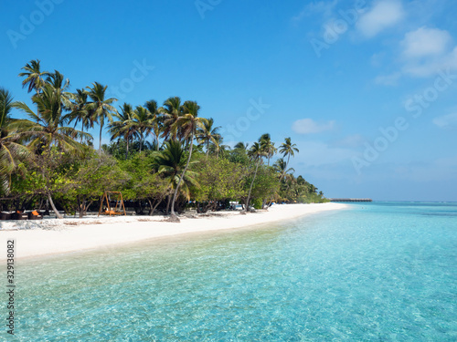 Beach on Maldives on Meeru Island with Palm Trees.