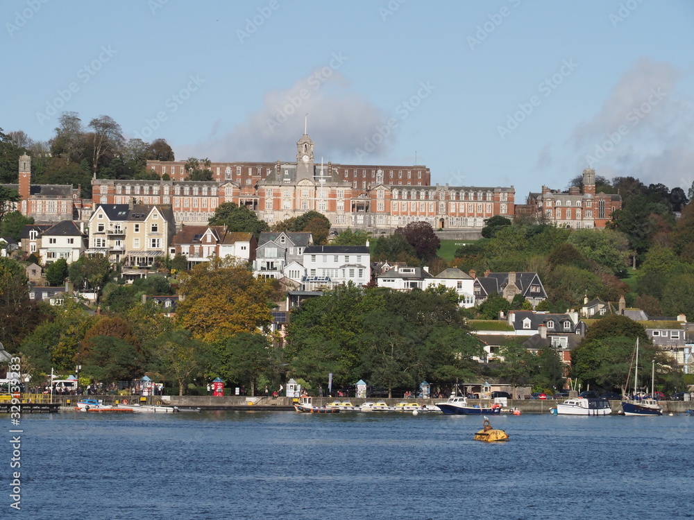 Britannia Naval College, also known as Dartmouth Naval College set on a hill in Dartmouth , Devon seen across the River Dart in sunshine