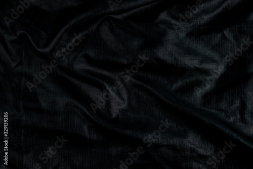 Black abstract background cloth and luxury liquid waves silk texture satin material