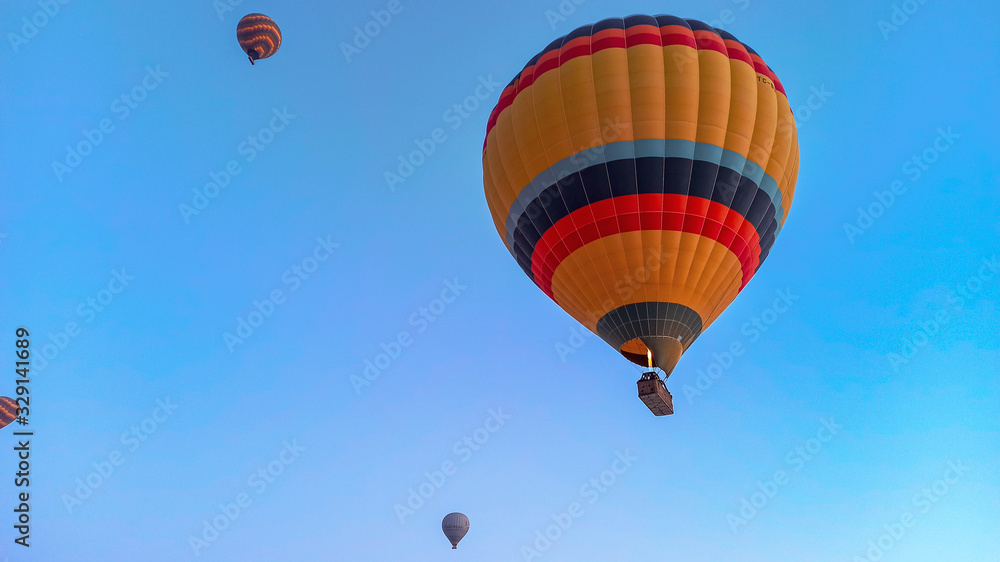 Hot air balloons preparing to fly at early morning in winter season in Cappadocia, Turkey Hot air balloons preparing to fly at early morning in winter season in Cappadocia, Turkey