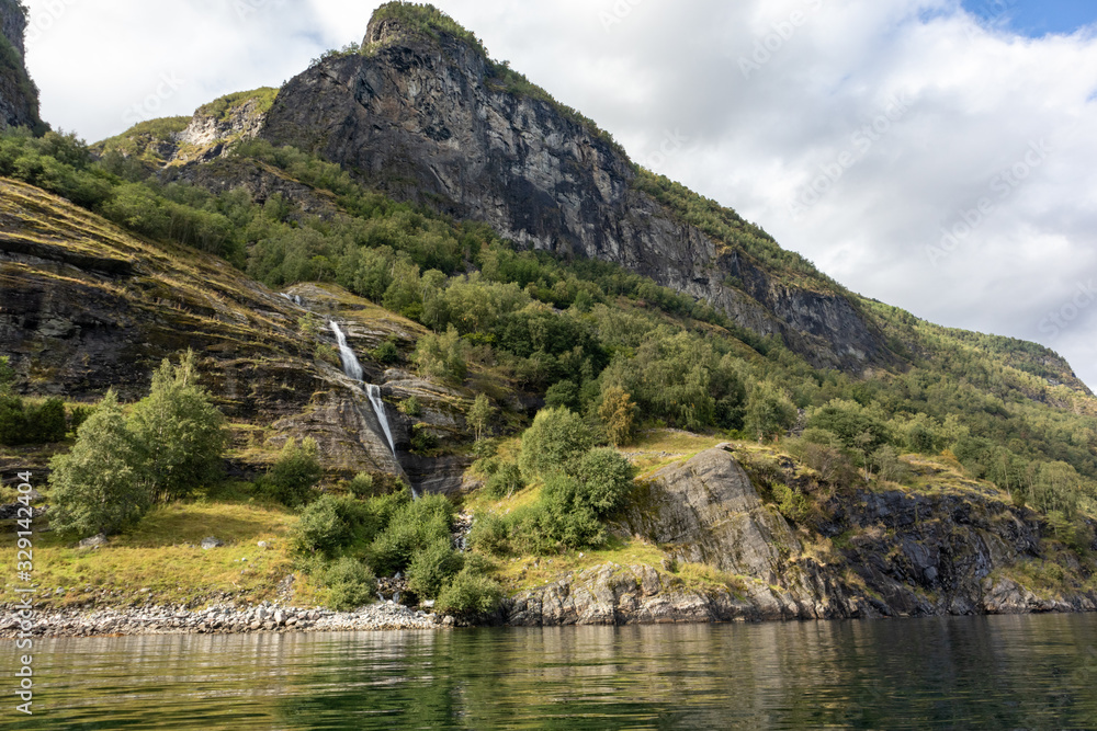 Waterfall falling in norwegian fjord Aurlandsfjord