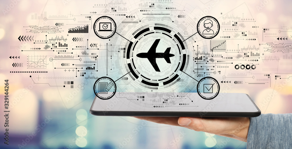 Fototapeta premium Flight ticket booking concept with man holding a tablet computer