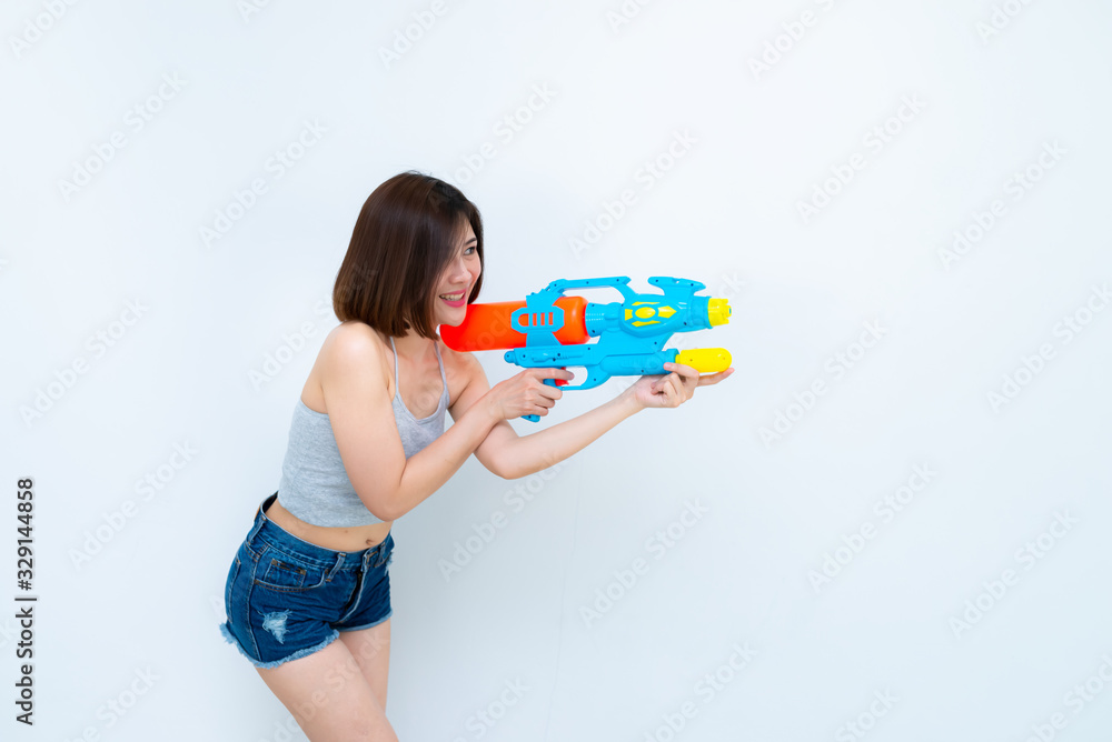 Asian sexy woman with gun water in hand on white background,Festival songkran day at thailand,The best of festival of thai,Land of smile Asian sexy woman with gun water in hand on white background,Festival songkran day at thailand,The best of festival of thai,Land of smile