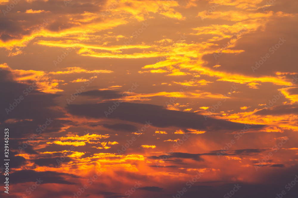 Fototapeta premium beautiful yellow sunrise among the clouds